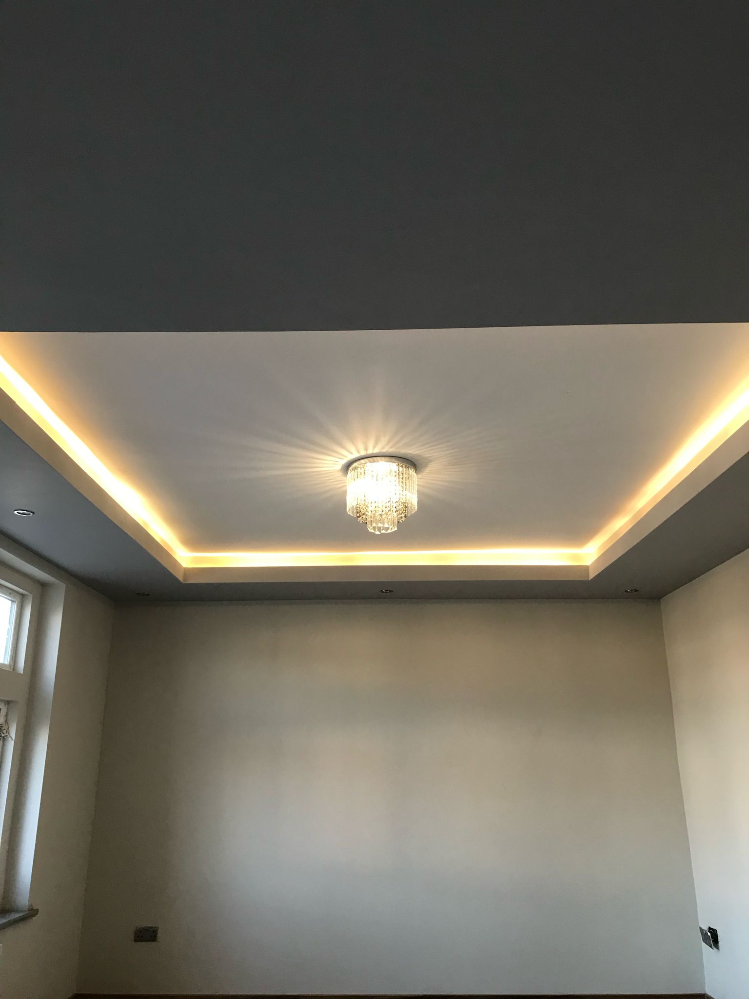 Ceiling coffer with LED strip lighting and crystal chandelier