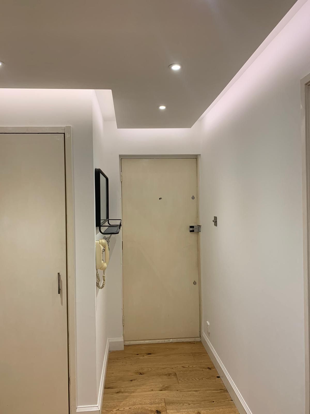 Hallway with recessed downlights and LED coffer ceiling lighting